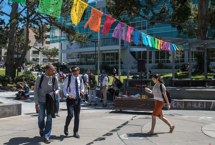 Students and faculty walking and mingling outside the Student Chavez Center