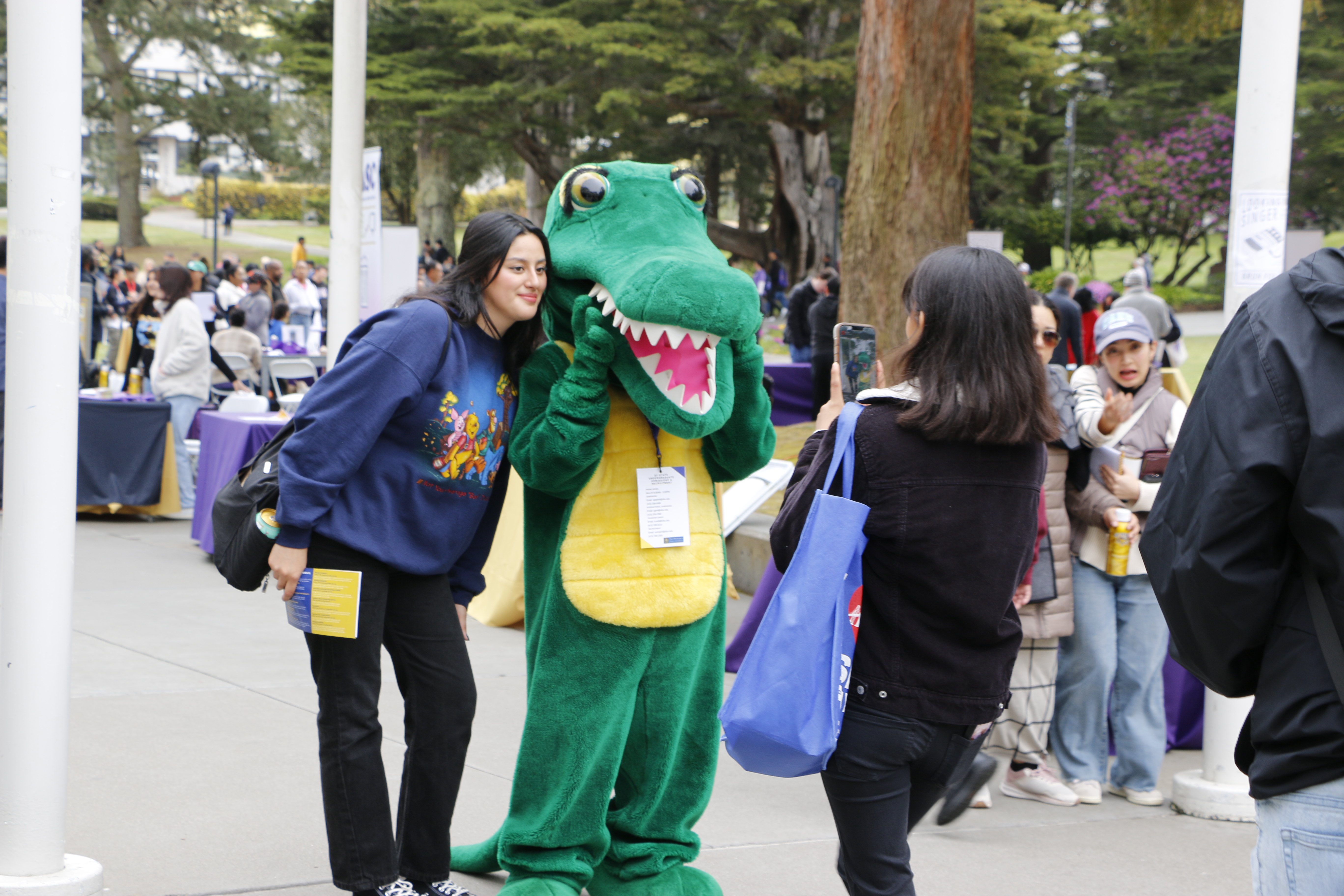 Ali Gator poses for a photo with an attendee at Explore SF State.